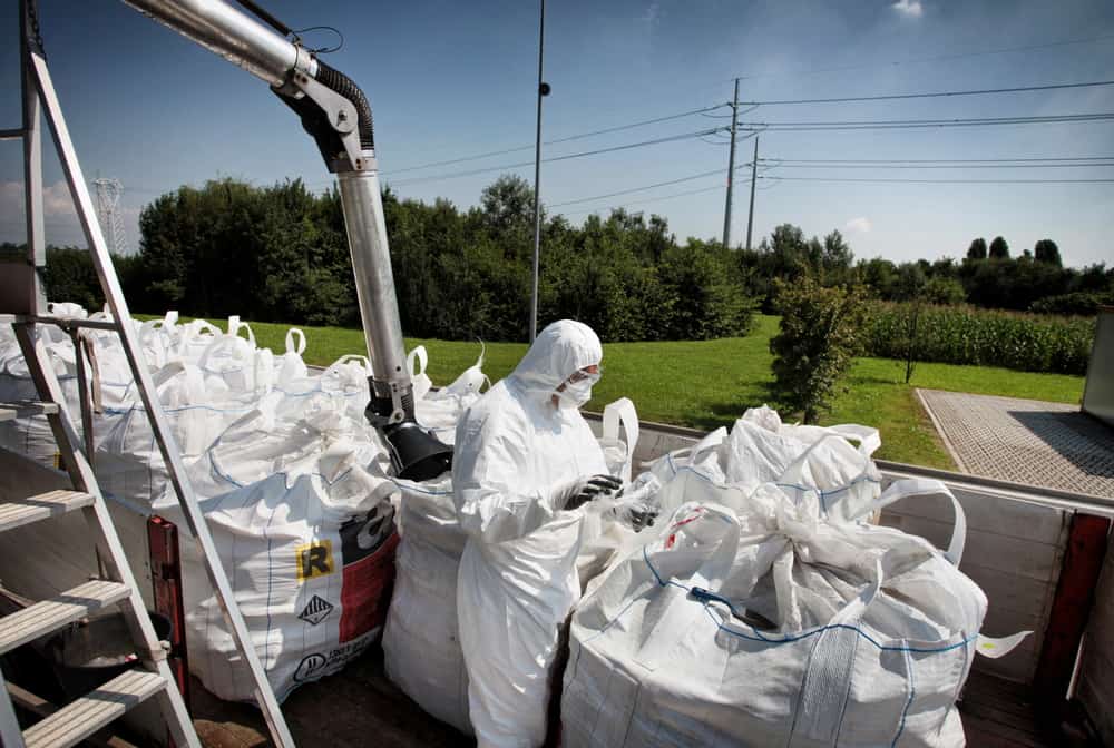 asbestos removalist pilig up asbestos in trash bags