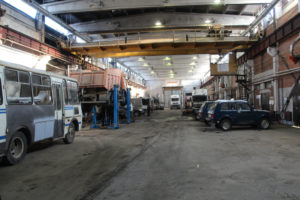MechanizedI ndustrial Workshop with a lots of abandon trucks and cars