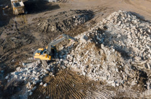 Recycling concrete and construction waste from demolition and excavator at Landfill
