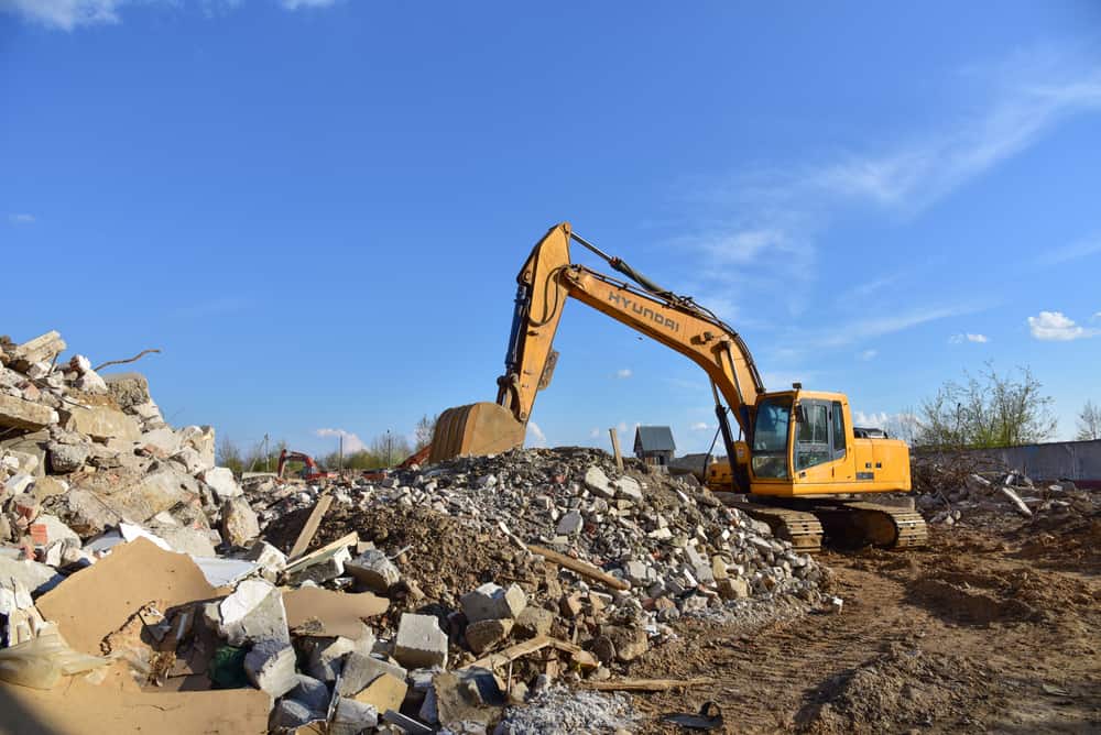 Brajkovich Demolition & Salvage excavator digging debris from the demolition